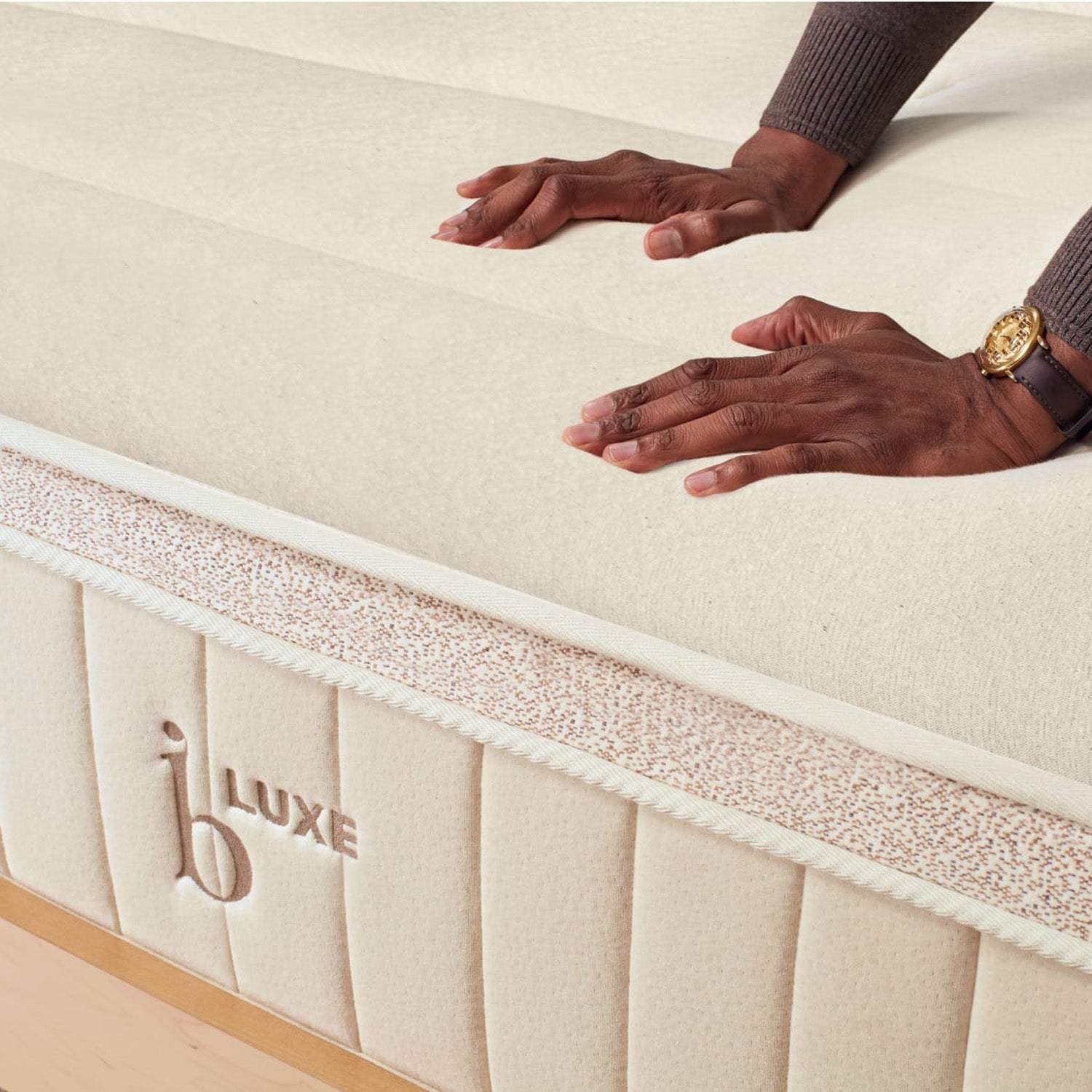 Birch Luxe Natural Mattress with hands