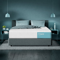 Casper Snow Hybrid Mattress in a modern room with lamps and blue back wall