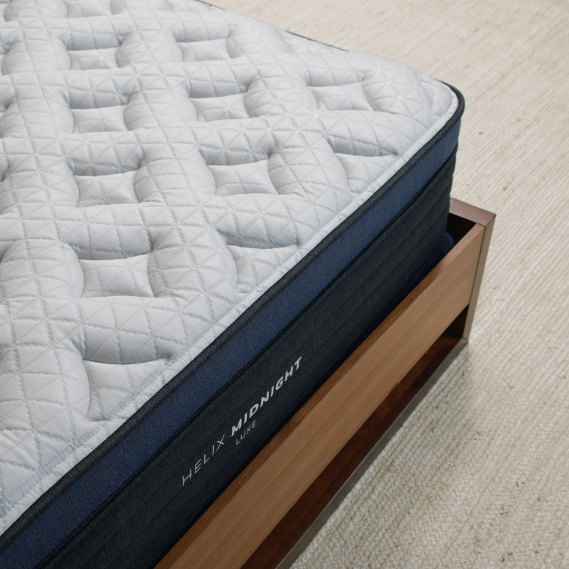 Corner of Bed showing Helix Midnight Luxe King Mattress 