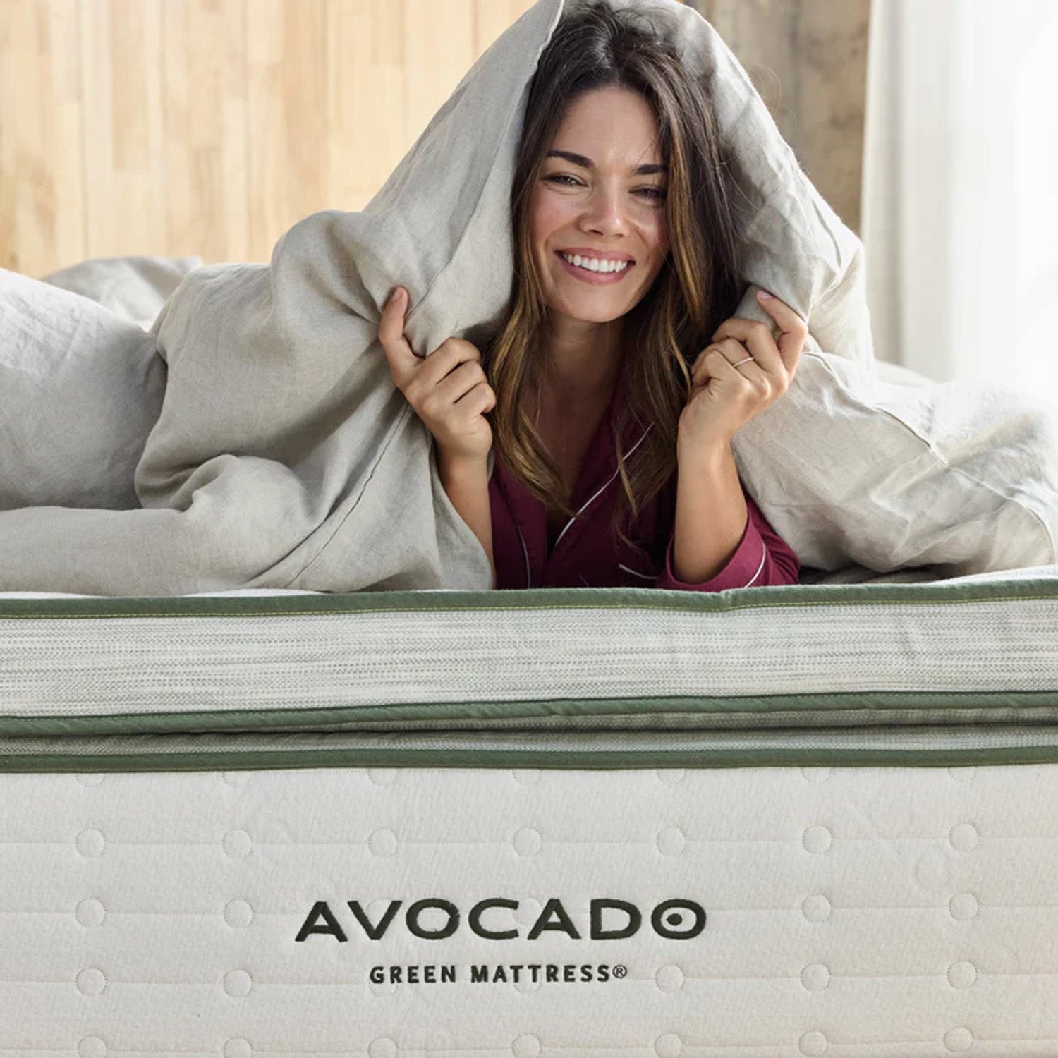 avocado green mattress plush female model covered by comforter